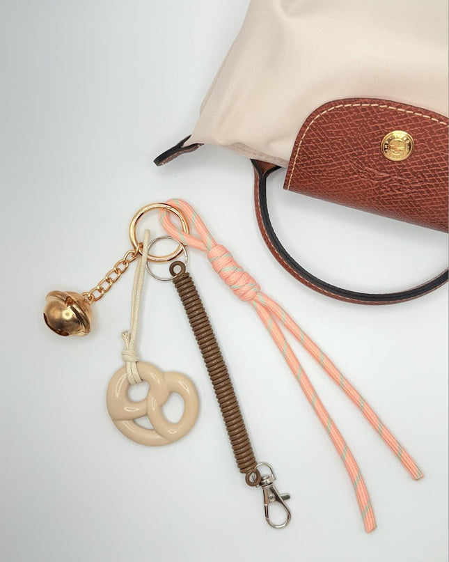 Pastel Bag Charm – Trendy Pink Knot, Gold Bell & Beige Pretzel Accessory